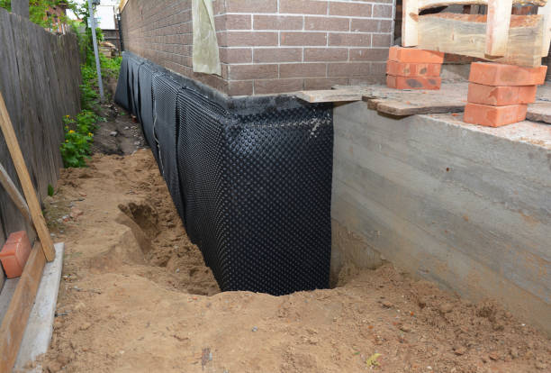 Happy homeowners after waterproofing job in Ossian